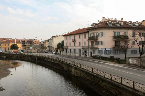 a bridge over a river in a city with buildings at Le Residenze Della Poetessa in Corsico