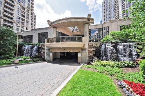 a building with a fountain in front of a building at PlanURstay - Luxury 1BR Condo with City View in Mississauga