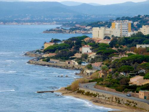a view of a beach with buildings and the ocean at Toi & Moi in Sainte-Maxime