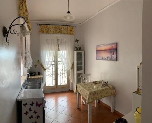 a kitchen with a table and a table and a sink at Apartment Terrazza Greca in Agrigento