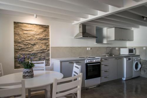 a kitchen with a table and a dining room at Anthi's House Center in Plomarion