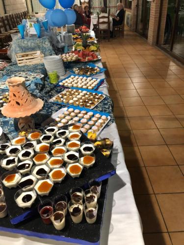 a row of tables filled with different types of sushi at Hotel River in Civitella Roveto