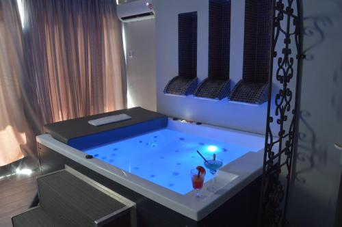 a room with a hot tub in a room at Anagenessis Resort in Kalamaki