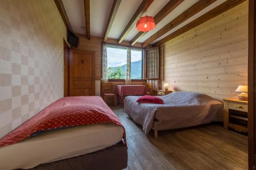 מיטה או מיטות בחדר ב-Les Sorbiers