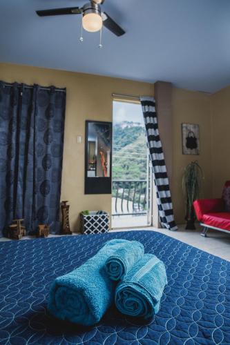 a bedroom with a bed with blue towels on it at The Valley Oasis Inn in Saint Joseph