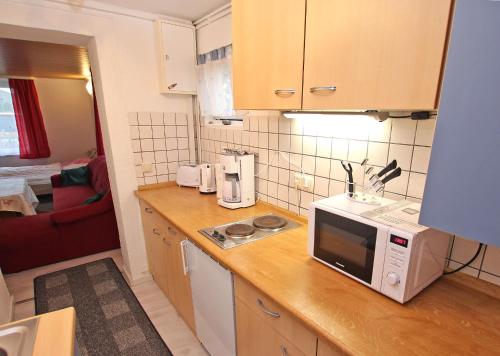 a kitchen with a counter top with a microwave at Ferienhaus Breege RUeG 1952 in Juliusruh