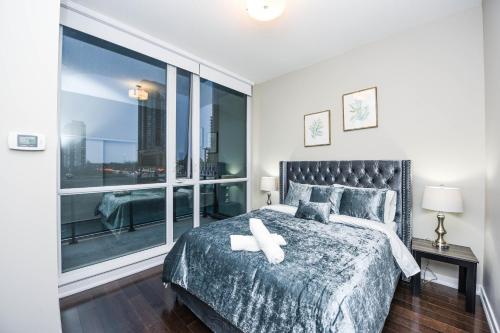 a bedroom with a bed and a large window at PlanURstay- Mississauga Downtown Square One Shopping Centre in Mississauga