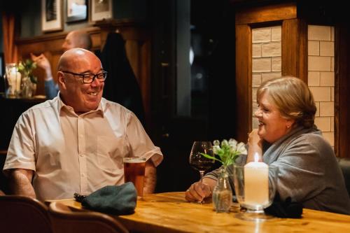 a man and a woman sitting at a table at Albert Arms in Esher