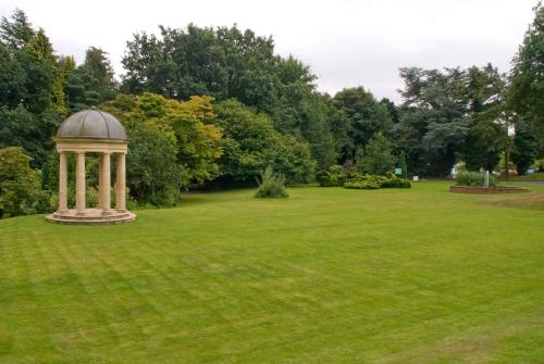 a gazebo in the middle of a grass field at Royal Court Hotel & Spa Coventry in Coventry