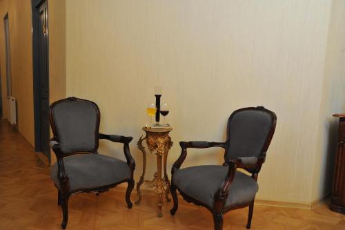 two chairs and a table with a candle in a room at Brickwall Tbilisi-Tbilisi vibe in Tbilisi City