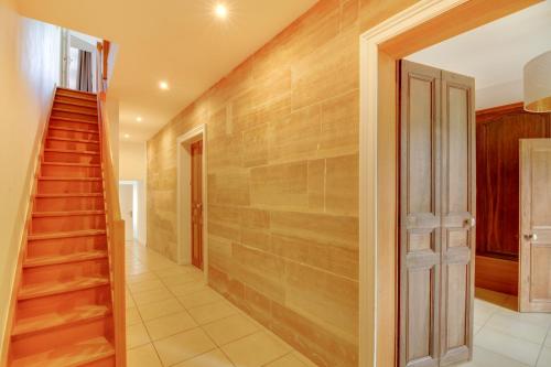 a hallway with wooden walls and stairs in a house at Maison d'hôtes La Villa des Ducs Bar-le-Duc in Bar-le-Duc