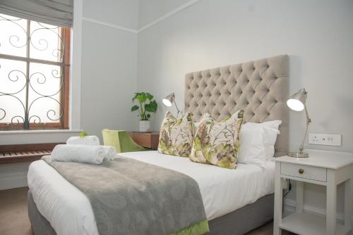 a bedroom with a large bed and a window at Bonne Esperance Boutique Guest House in Stellenbosch