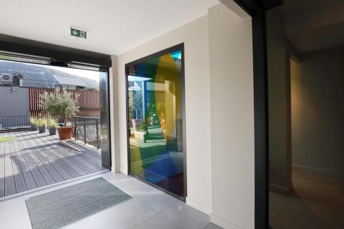 a glass door of a house with a rainbow at Hôtel la Capelle Millau in Millau