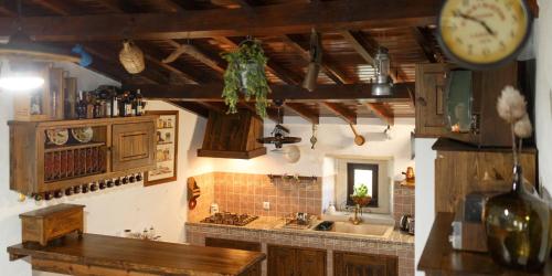 a kitchen with a counter and a clock on the wall at Quinta dos Canteiros in Fátima