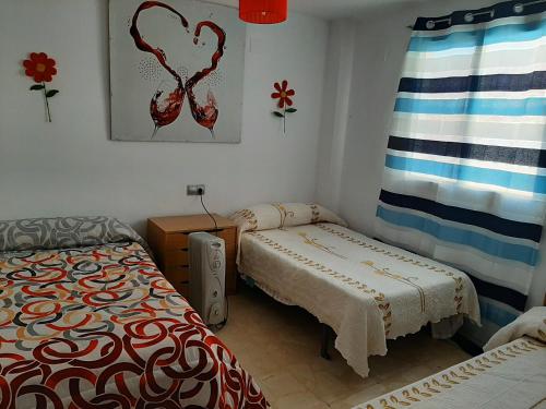 Postel nebo postele na pokoji v ubytování Calle Quevedo, 27 Apartamento. Feria