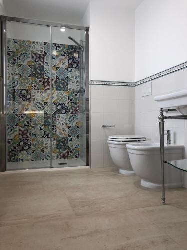 a bathroom with a shower and a toilet and a sink at le terrazze sul mare gallipoli centro in Gallipoli