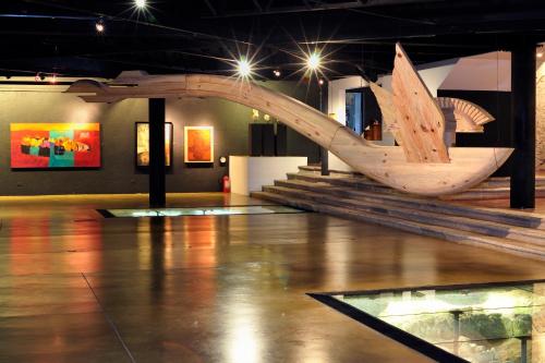 a wooden boat on display in a museum at Hotel Museo Spa Casa Santo Domingo in Antigua Guatemala