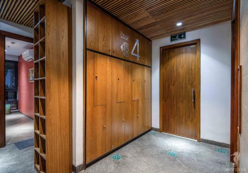 a hallway with two wooden doors in a building at Seahorse Han Market Da Nang Apartment by Haviland in Danang