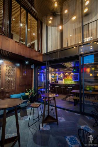 a restaurant with tables and chairs in a building at Seahorse Han Market Da Nang Apartment by Haviland in Danang