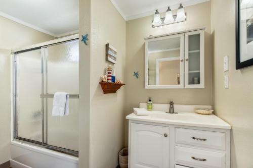 a bathroom with a sink and a shower at The Wallace Beach House in Lincoln Beach