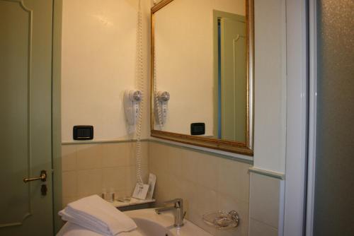 uma casa de banho com um lavatório e um espelho em B&B Ortensia em Forte dei Marmi