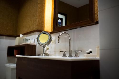 a bathroom with a sink with a mirror on it at Hotel Valencia Santana Row in San Jose