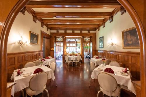 a restaurant with tables and chairs in a room at Vinifera Inn in Geneva