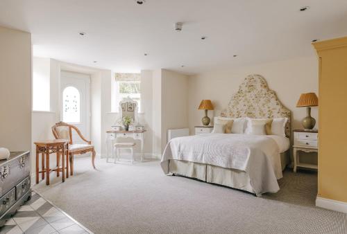 a bedroom with a bed and a table and chairs at Tyndall Villa Boutique B&B in Bath