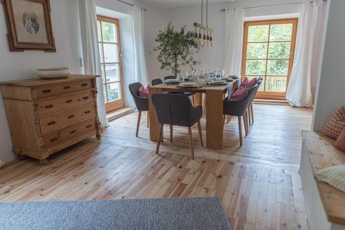a dining room with a wooden table and chairs at Gipfelkönig in Bayrischzell