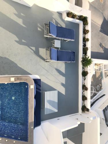 a building with blue and white at Altana Cliffside Villas in Imerovigli