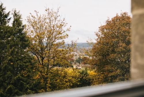 a view from a window of trees in the fall at Tyndall Villa Boutique B&B in Bath
