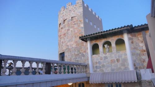 a building with a balcony next to a tower at Résidence Hôtelière Océane in Lomé