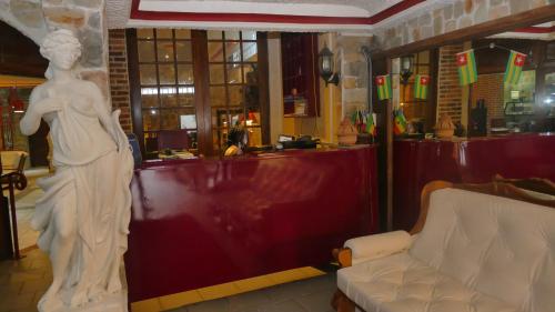 a statue of a woman standing next to a bar at Résidence Hôtelière Océane in Lomé