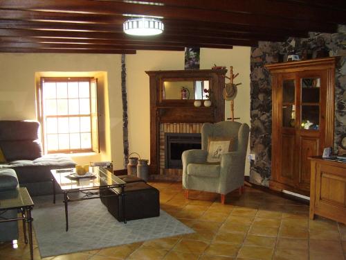 a living room with a couch and a fireplace at Casa Doña Justa in Tegueste