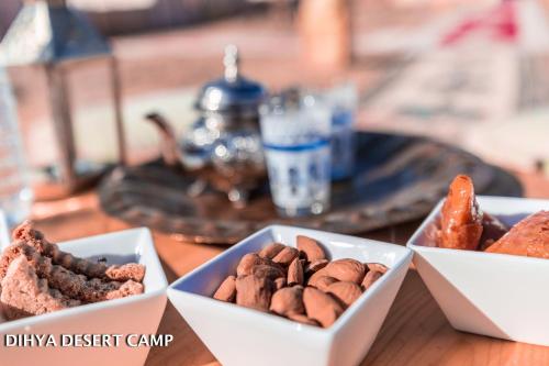 three bowls of different types of nuts on a table at Dihya desert camp in Merzouga