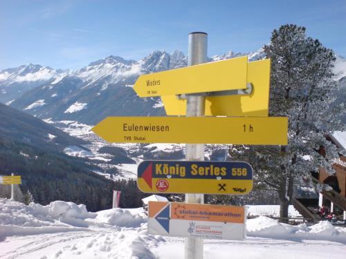a pole with a bunch of signs on a mountain at Haus Hubertus in Mieders