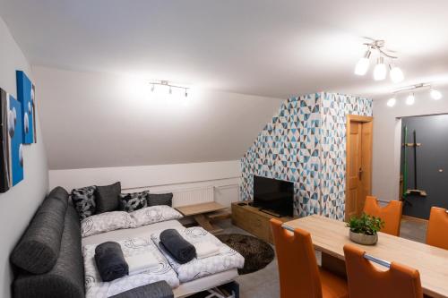 a living room with a couch and a table at Apartma Borovnica Rogla in Vitanje