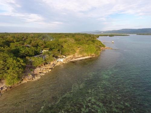 an aerial view of an island in a body of water at Rene's Diverslounge Resort in Calape