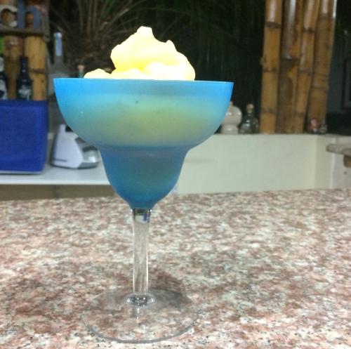 a blue drink in a martini glass on a counter at Casa Blue Tortuga in Ballenita