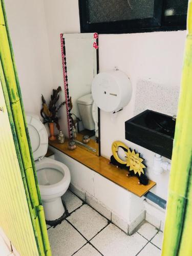 a bathroom with a toilet and a sink at Hostal Pampaloja Antof in Antofagasta