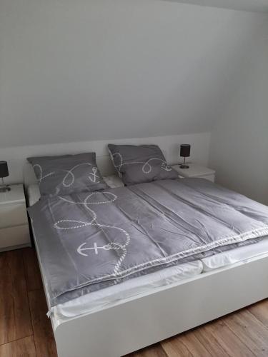 a bed in a bedroom with two night stands at Backbord in Wangerland