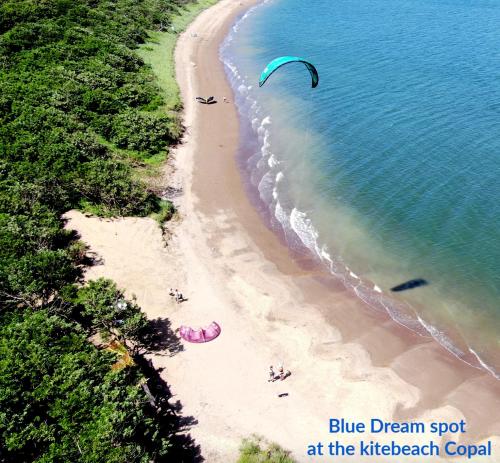 a group of people on a beach flying a kite at Blue Dream Kite Boarding Resort Costa Rica in Puerto Soley