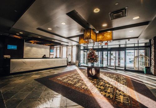 a lobby with a table in the middle of a room at The Explorer Hotel in Yellowknife