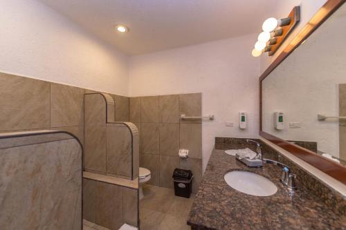 a bathroom with a sink and a toilet at Del Sol Beachfront in Akumal