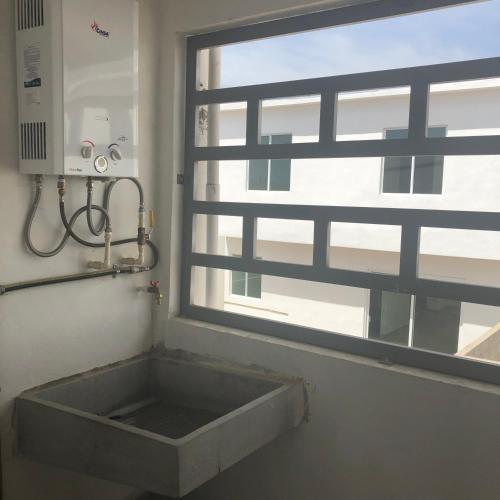 a sink in a bathroom next to a window at Condo Vacational in Ensenada, B.C. in Ensenada