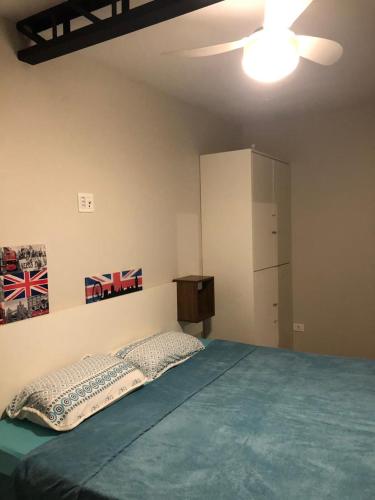 a bedroom with a bed and a ceiling fan at Bela Curitiba Hostel in Curitiba