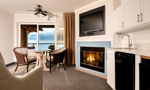 a kitchen with a fireplace and a table with chairs at Hallmark Resort - Newport in Newport