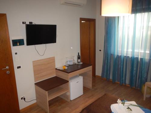 a living room with a flat screen tv on the wall at Garni Villa Betty in Merano