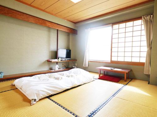 Postel nebo postele na pokoji v ubytování business ryokan haniwa