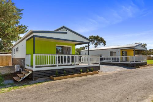 a house with a green and white at Victor Harbor Holiday Park in Victor Harbor